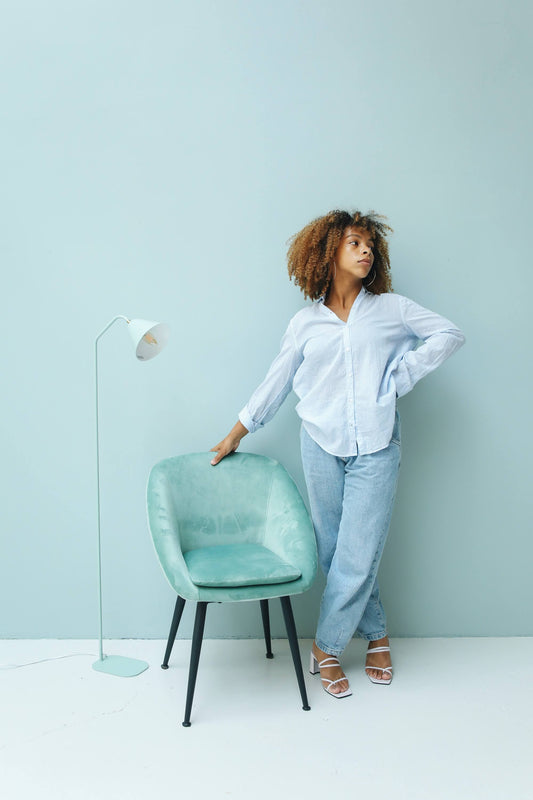 woman wearing button down shirt and blue slouchy jeans