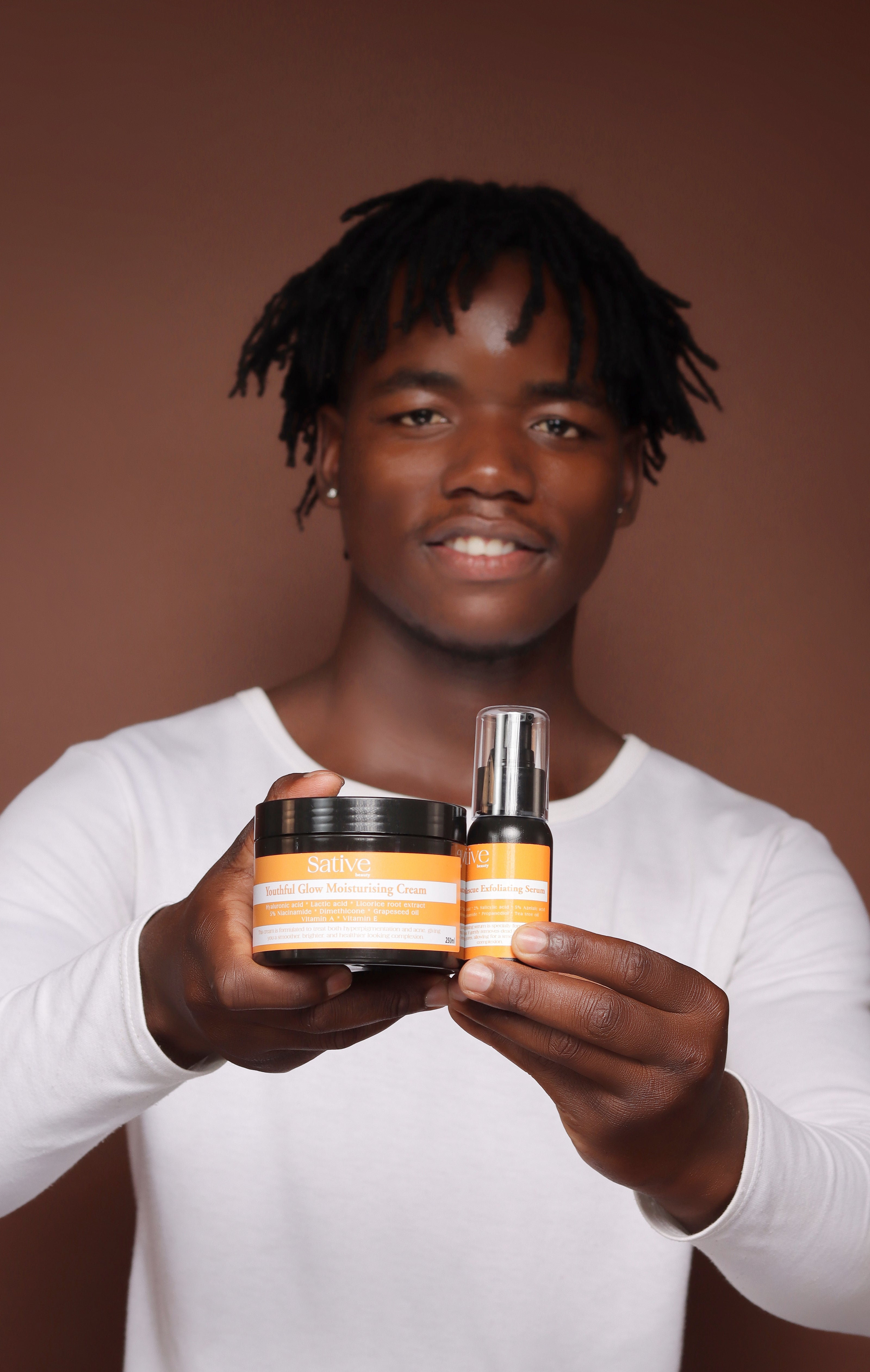 male model posing with skincare product