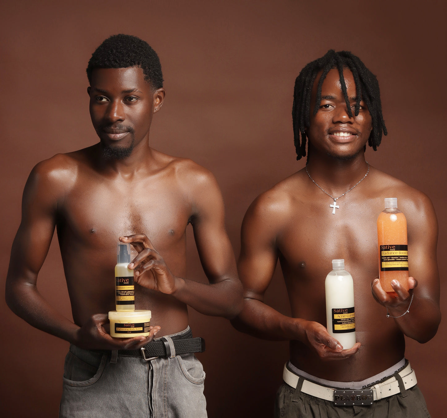 Two men holding skin care products against a brown background
