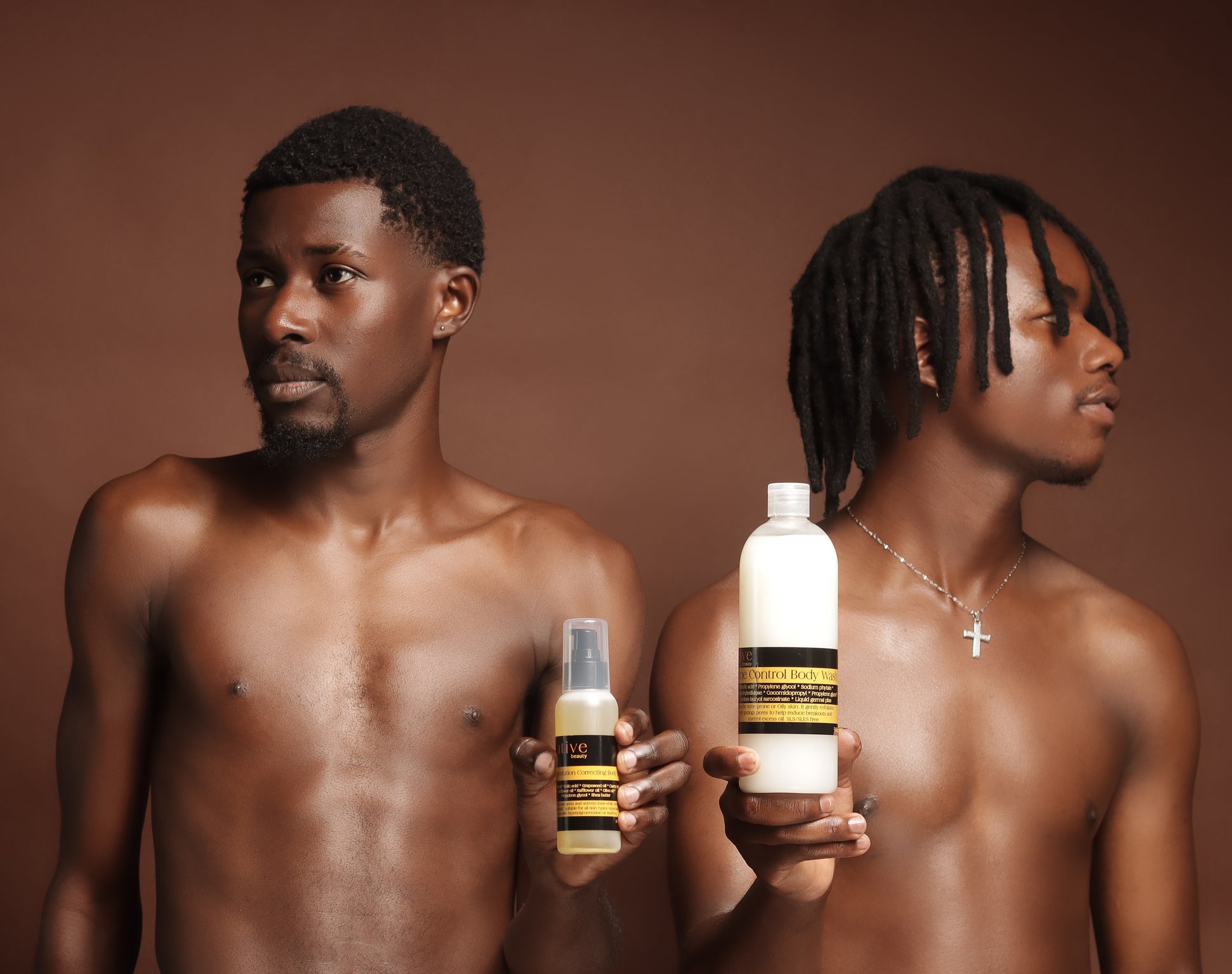 Two men holding skin care products against a brown background
