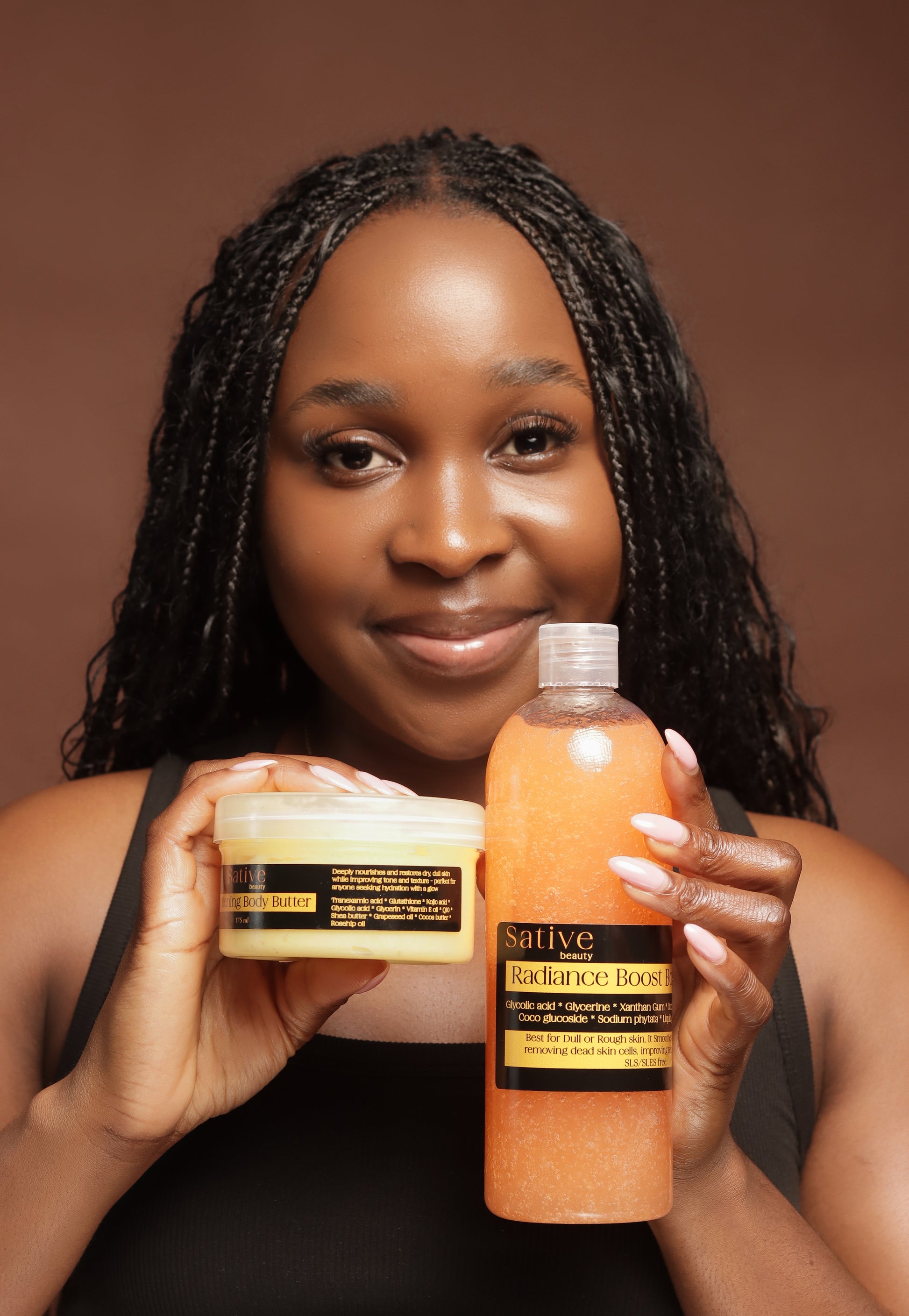 Woman holding a bottle and jar of Sative skin care products against a brown background