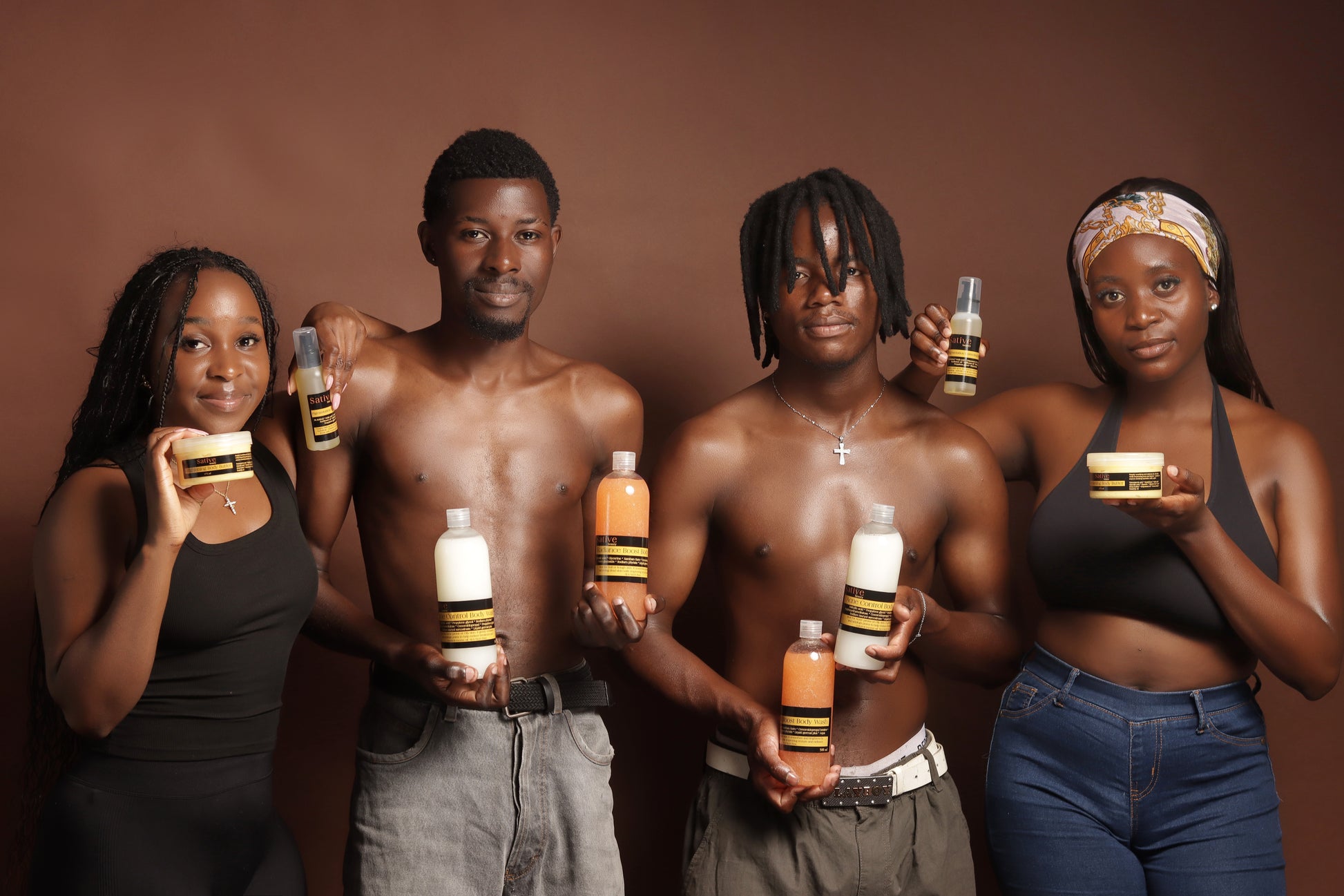 Five people holding skincare products against a brown background