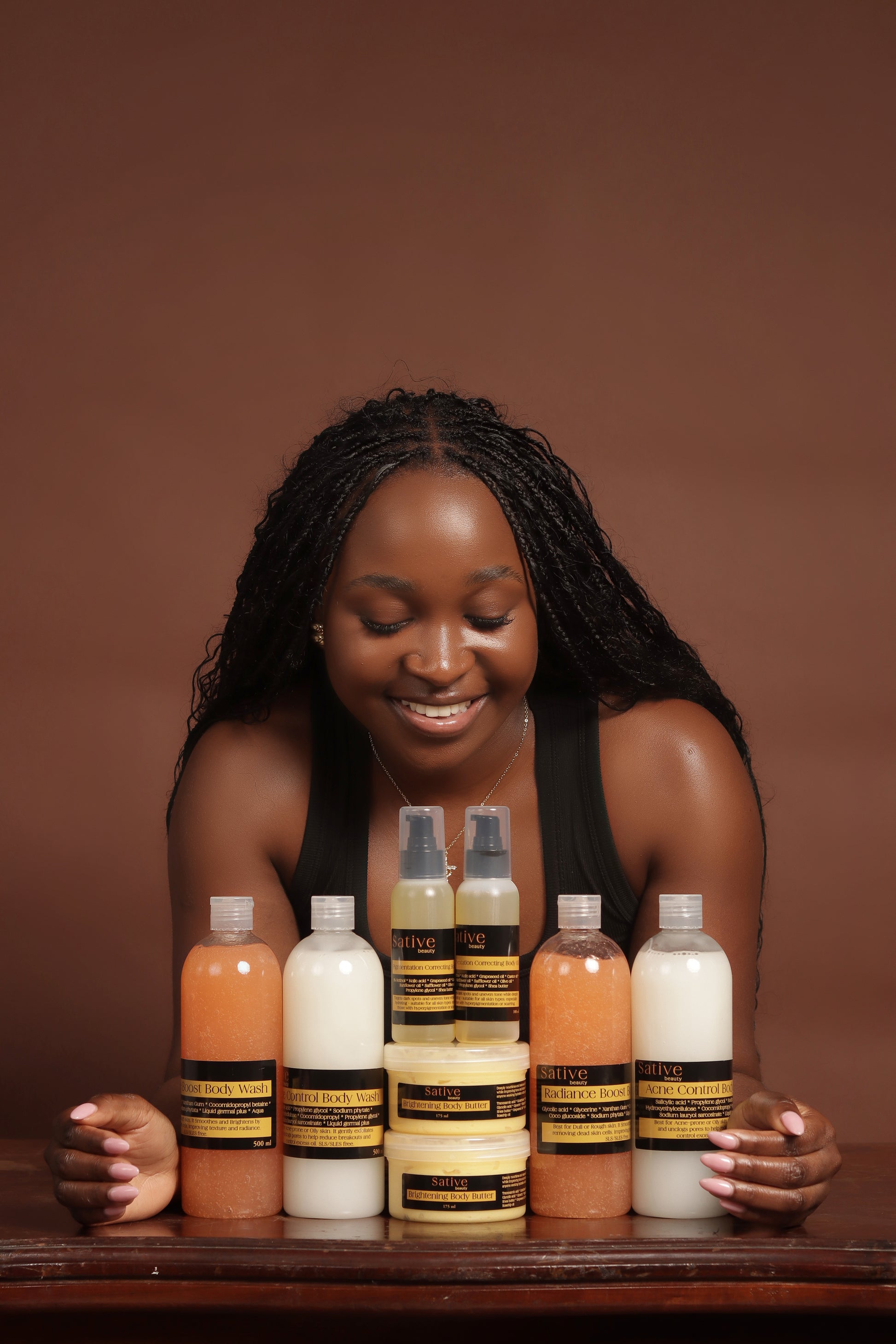 Woman with skin care products on a brown background