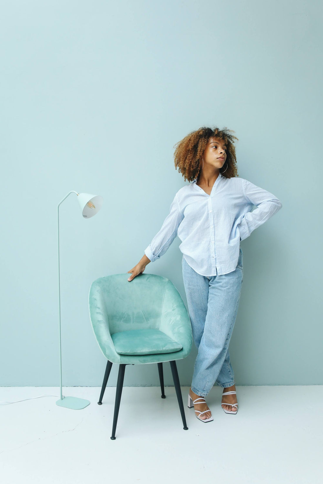 woman wearing button down shirt and blue slouchy jeans