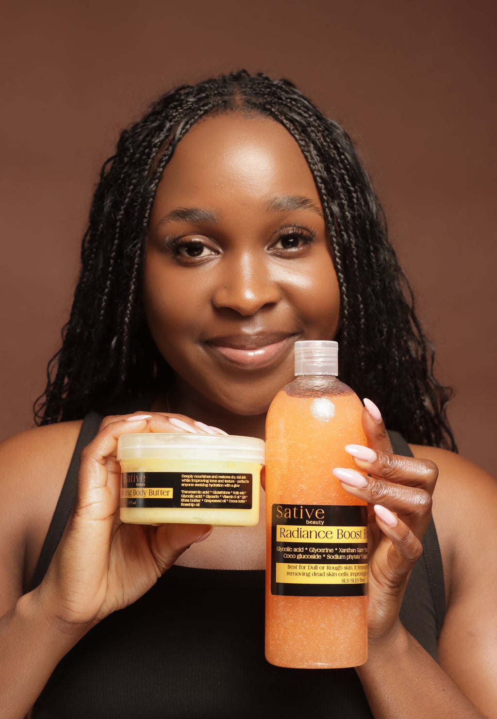 Woman holding a bottle and jar of Sative skin care products against a brown background