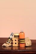 Three skincare products on a wooden surface with a beige background